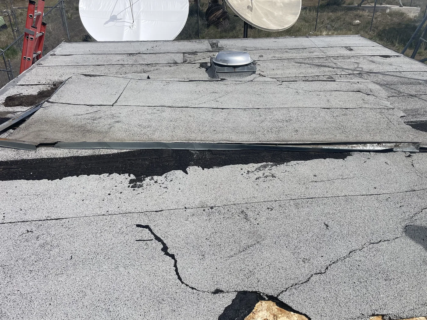 Before photo of an Alturas low-slope roof project by Linkville Roofing and Siding