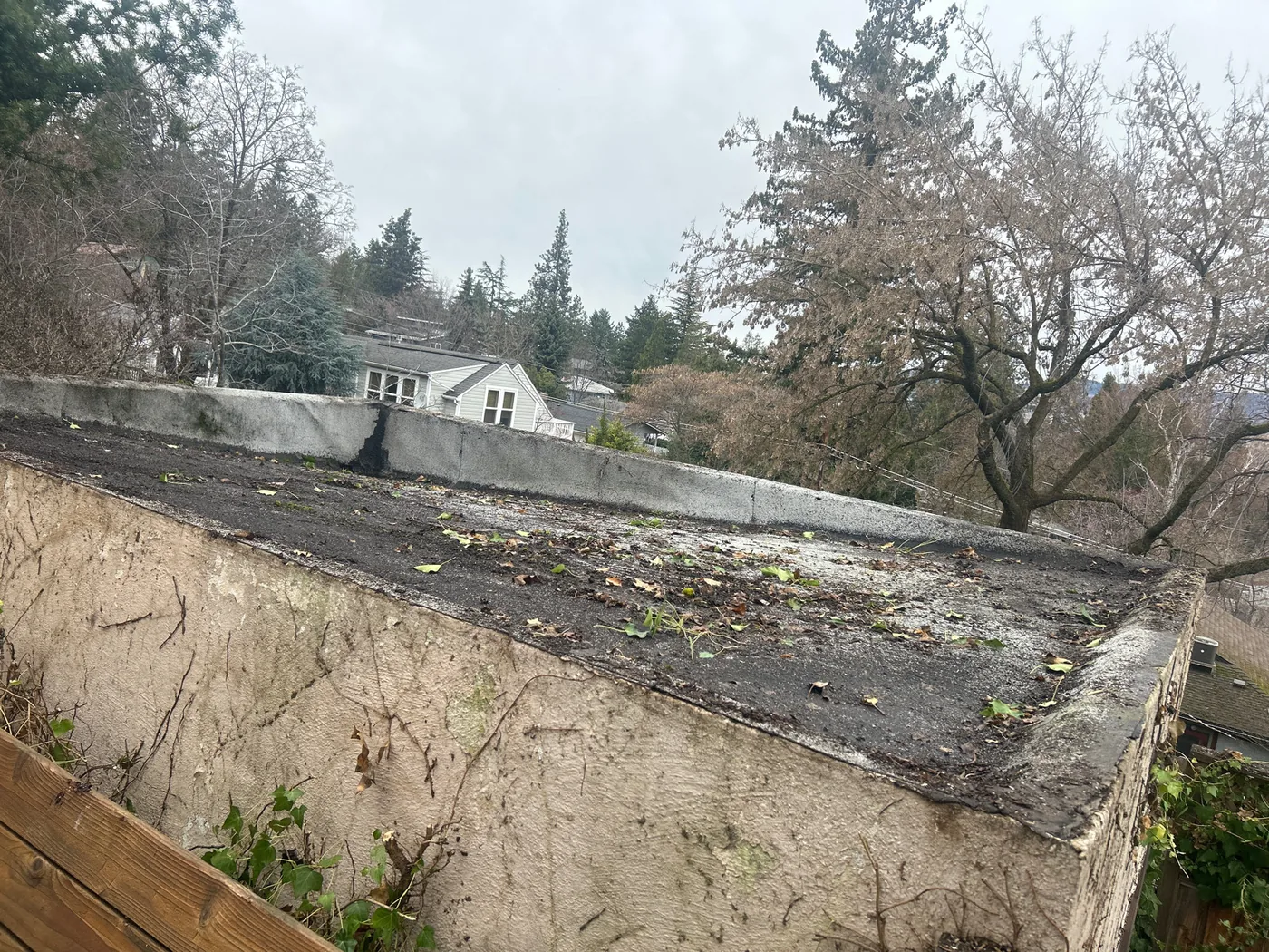 Before photo of an Ashland low-slope roof project by Linkville Roofing and Siding