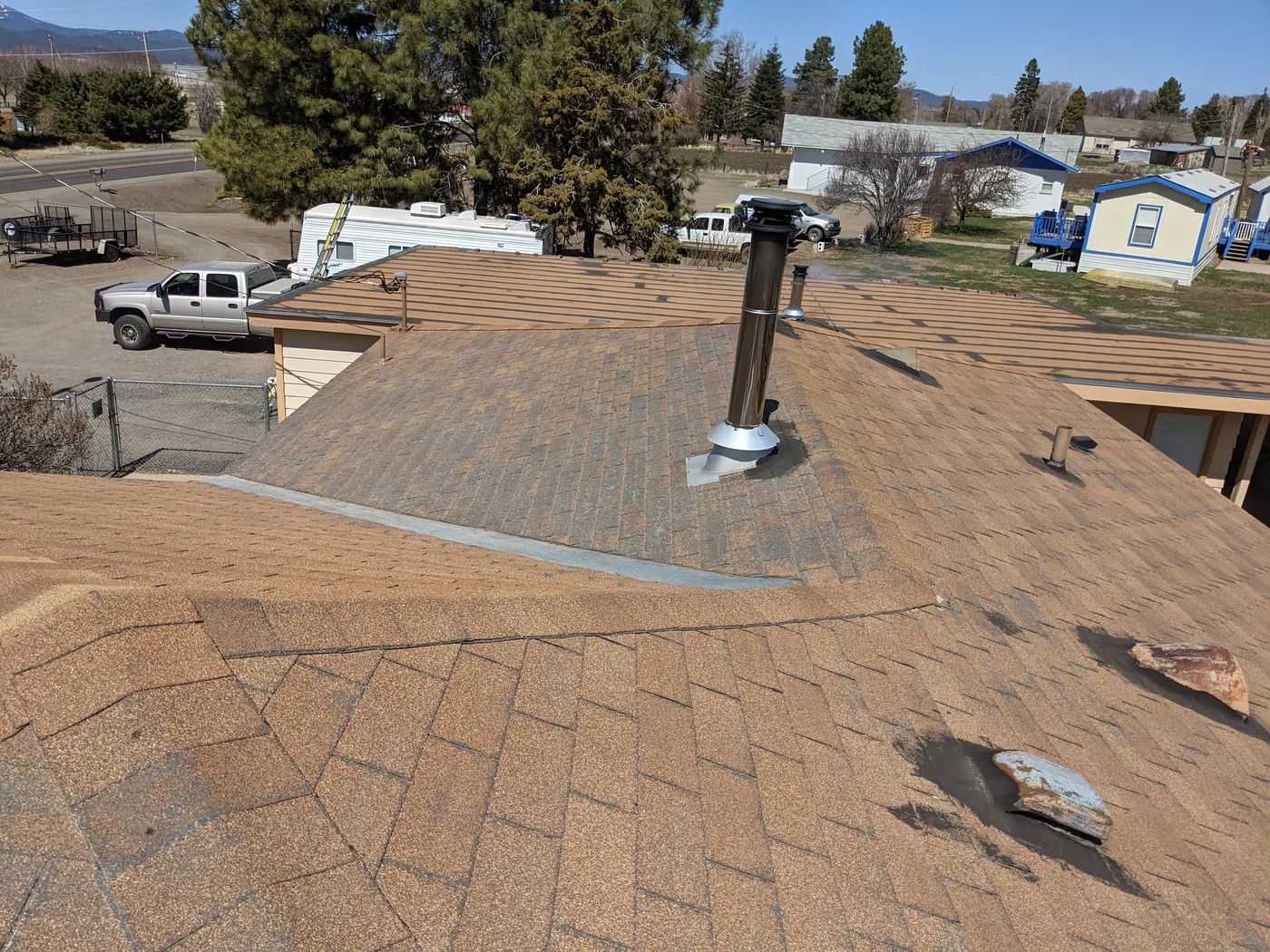 Before photo of a Lakeview shingle and low-slope roof project by Linkville Roofing and Siding