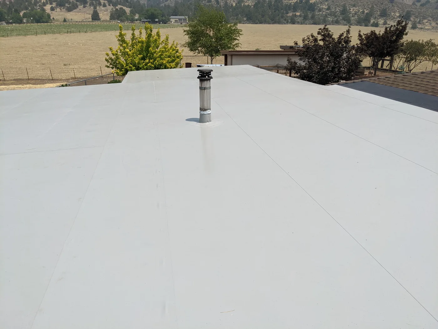 After photo of a completed Lakeview low-slope roof section by Linkville Roofing and Siding