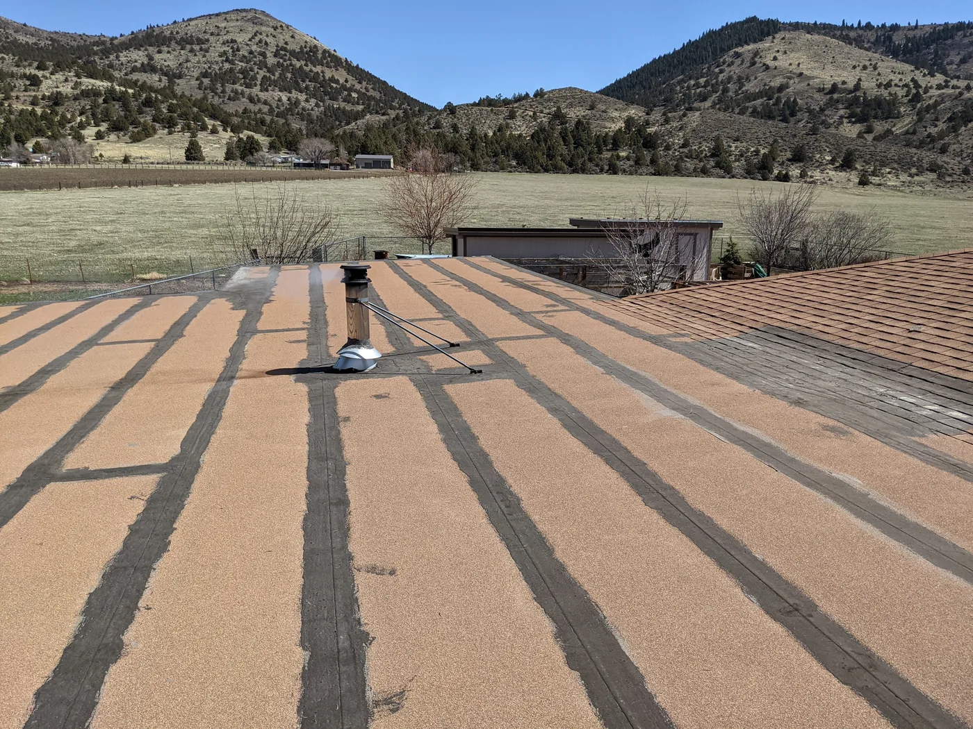 Before photo of a Lakeview low-slope roof section by Linkville Roofing and Siding