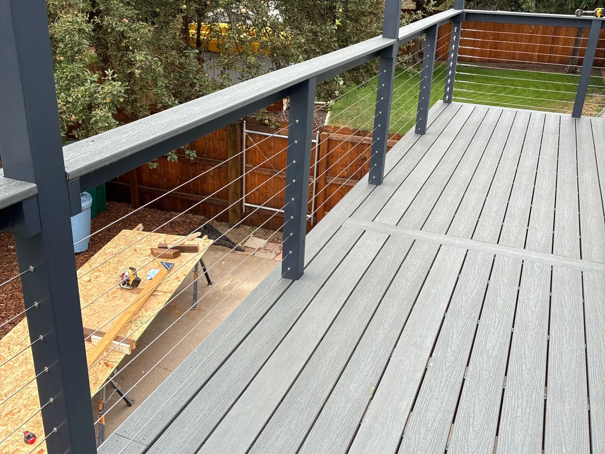 After deck installation showing updated gray decking and cable railing at a Klamath Falls home