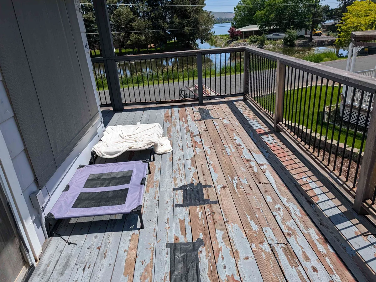 Before deck installation showing worn deck boards and older railing at a Klamath Falls home
