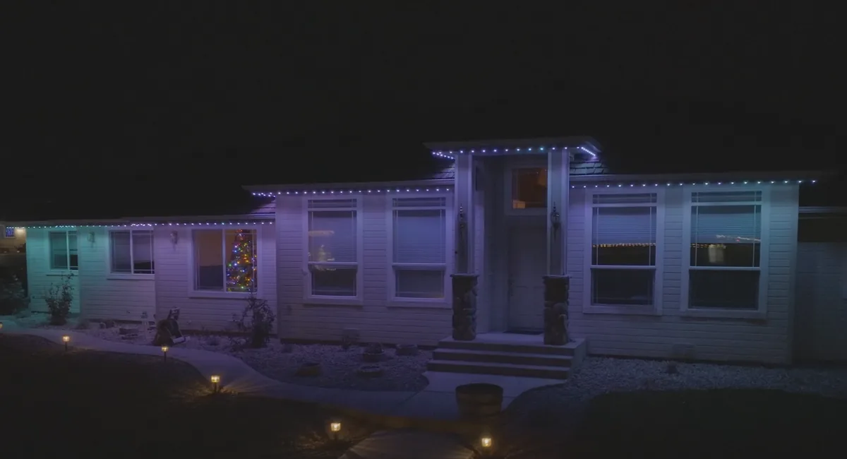 Full home with permanent outdoor lighting set to multiple colors at night