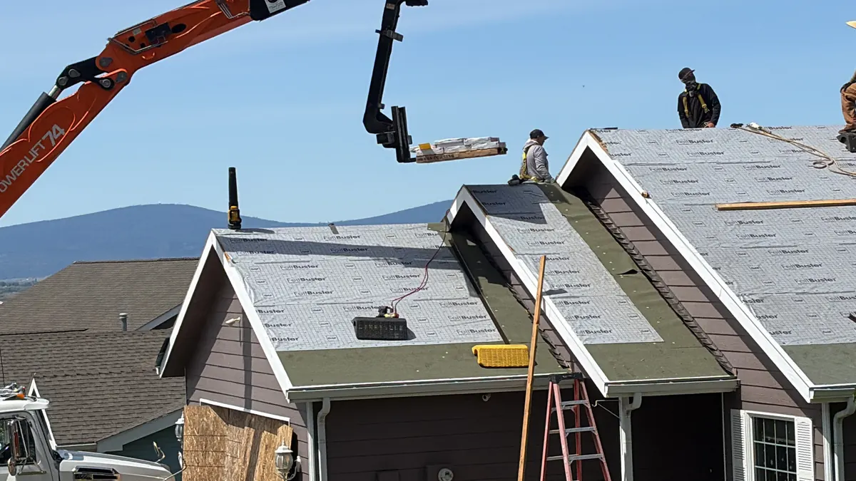 Linkville Roofing and Siding crew installing underlayment during a roof installation project
